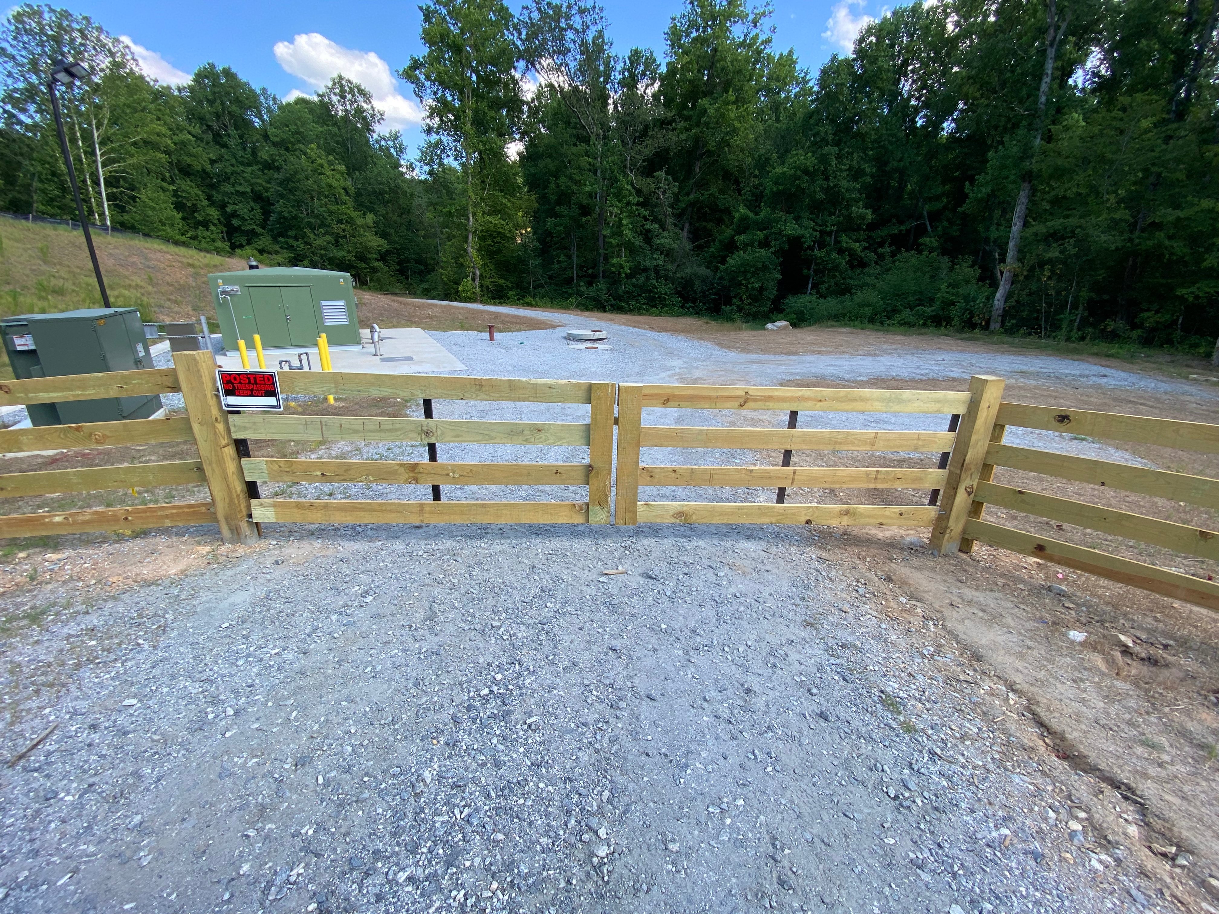 Wood double entrance gate shown on Fleming Fencing’s gate service page